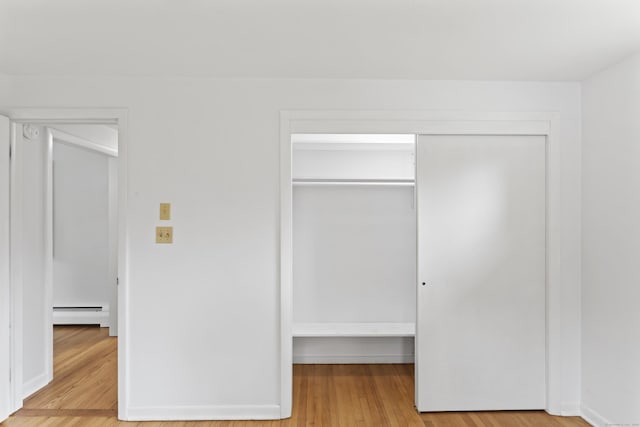 119 Debra Ln, Bristol, CT 06010 - unfurnished bedroom featuring a closet, baseboard heating, and wood finished floors