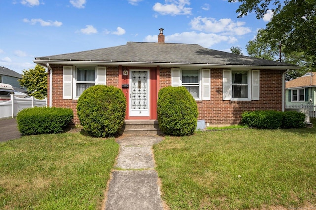 5 Hale Ct, Plainville, CT 06062 - view of front facade featuring brick siding, a front lawn, a chimney, and a shingled roof