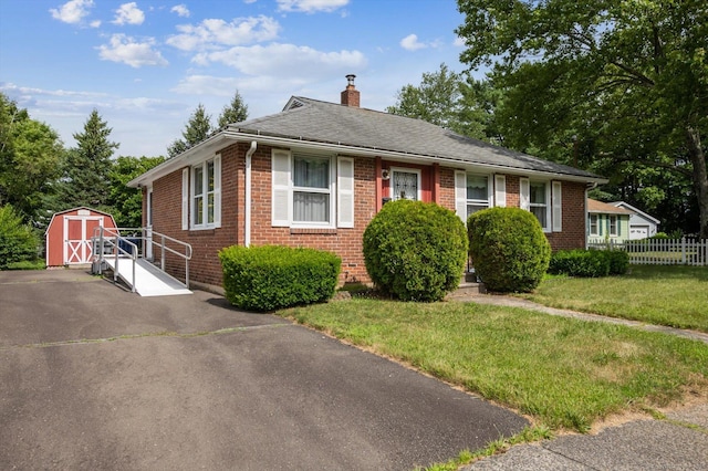5 Hale Ct, Plainville, CT 06062 - view of front of home featuring a shed, a chimney, brick siding, and roof with shingles