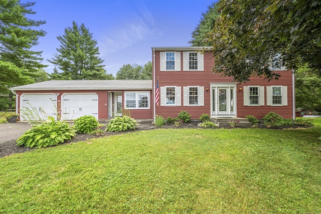 148 Depot St, East Windsor, CT 06016 - colonial inspired home with asphalt driveway, a garage, and a front lawn