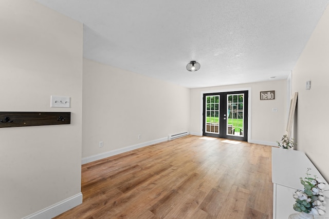 148 Depot St, East Windsor, CT 06016 - unfurnished room featuring a baseboard radiator, light wood-style floors, and a textured ceiling