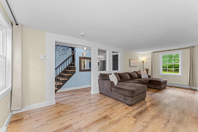 148 Depot St, East Windsor, CT 06016 - living room with wood finished floors, stairs, a textured ceiling, and a baseboard radiator