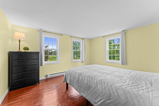 148 Depot St, East Windsor, CT 06016 - bedroom featuring a baseboard heating unit and wood finished floors