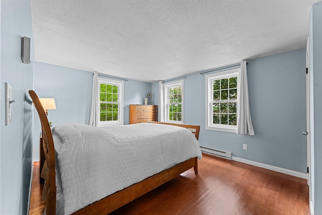 148 Depot St, East Windsor, CT 06016 - bedroom with a baseboard heating unit, hardwood / wood-style flooring, and a textured ceiling