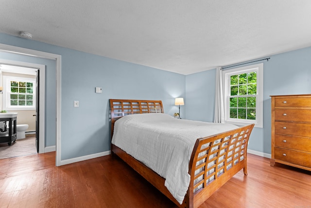 148 Depot St, East Windsor, CT 06016 - bedroom featuring wood finished floors, multiple windows, and baseboard heating