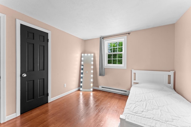 148 Depot St, East Windsor, CT 06016 - unfurnished bedroom featuring a baseboard radiator and wood finished floors