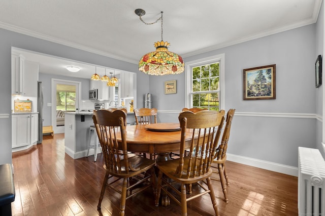 50 Spring Glen Dr, Granby, CT 06035 - dining area featuring plenty of natural light, radiator, ornamental molding, and dark wood finished floors