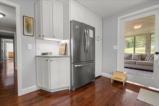 50 Spring Glen Dr, Granby, CT 06035 - kitchen featuring freestanding refrigerator, dark wood finished floors, white cabinets, backsplash, and light stone countertops