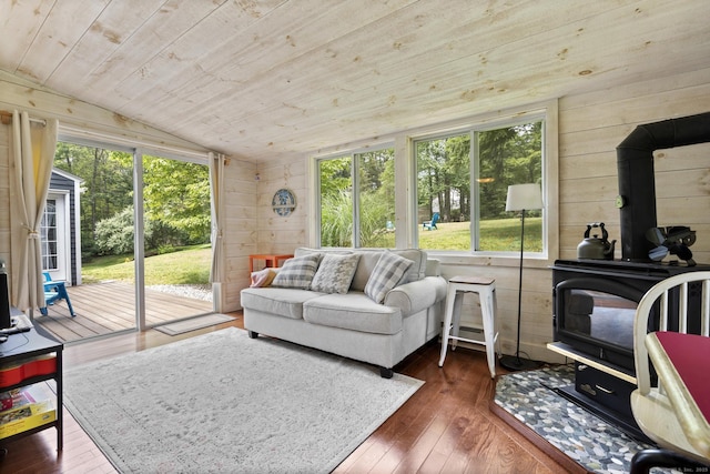 50 Spring Glen Dr, Granby, CT 06035 - living area with a wood stove, wood ceiling, vaulted ceiling, dark wood-style flooring, and wood walls