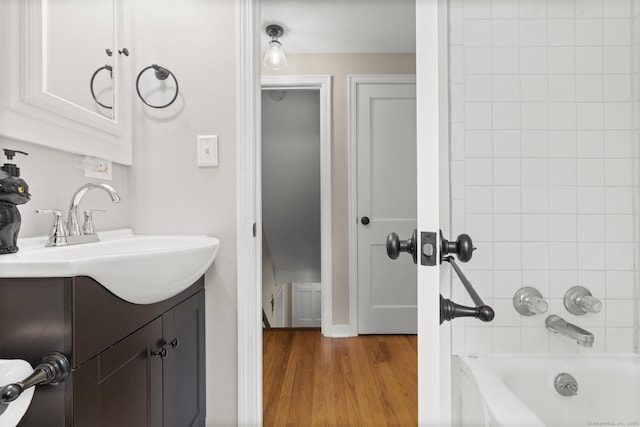 50 Spring Glen Dr, Granby, CT 06035 - bathroom featuring vanity, wood finished floors, and washtub / shower combination