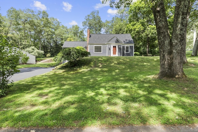 50 Spring Glen Dr, Granby, CT 06035 - view of front facade featuring a chimney, a front lawn, and roof with shingles