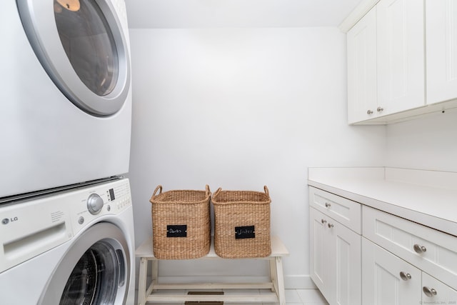319 Main St, Wethersfield, CT 06109 - laundry room featuring stacked washer and clothes dryer and cabinet space