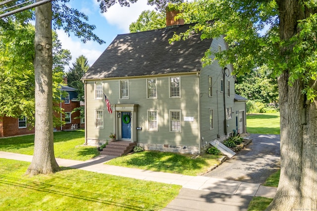 319 Main St, Wethersfield, CT 06109 - view of front facade with a chimney, a front yard, a shingled roof, and asphalt driveway