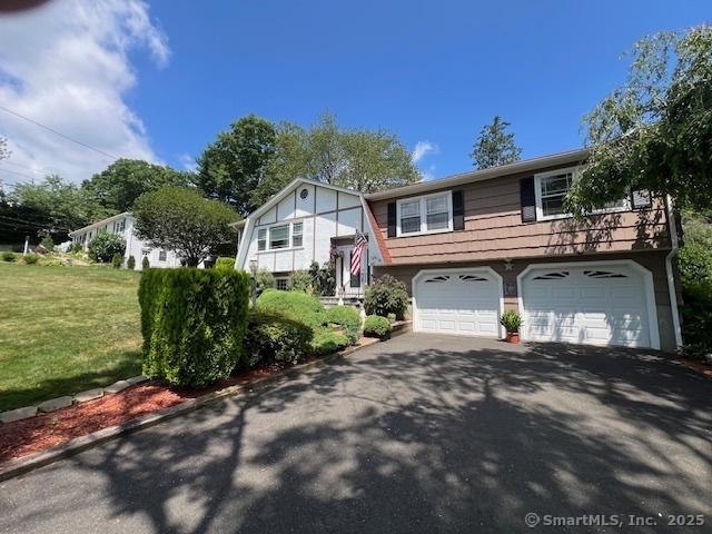 38 Pine St, Trumbull, CT 06611 - raised ranch with driveway, a garage, and a front yard