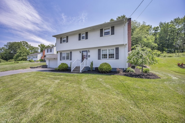18 Holly Ln, Wallingford, CT 06492 - view of front of home with a chimney, driveway, a front lawn, and a garage
