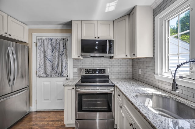 18 Holly Ln, Wallingford, CT 06492 - kitchen with stainless steel appliances, healthy amount of natural light, tasteful backsplash, dark wood-style flooring, and crown molding