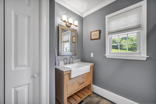 18 Holly Ln, Wallingford, CT 06492 - bathroom featuring vanity, ornamental molding, baseboard heating, and wood finished floors