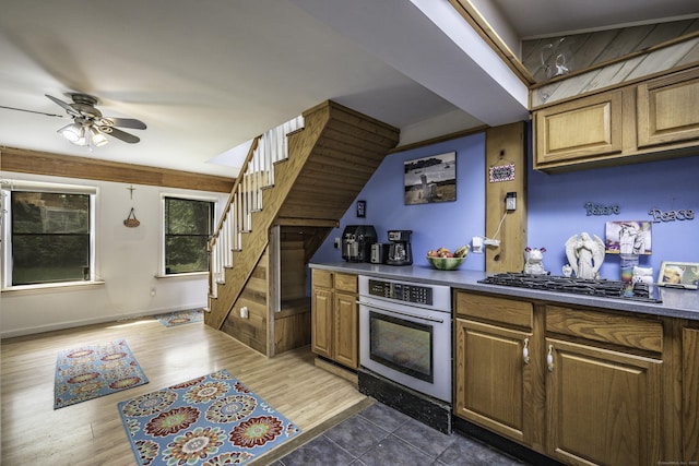 72 S Rd, Portland, CT 06480 - kitchen with stainless steel oven, gas stovetop, a ceiling fan, dark countertops, and wood finished floors