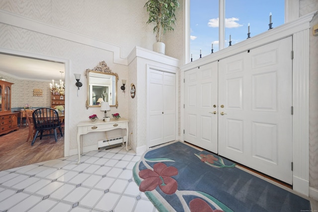 21 Hidden Pond Dr, Watertown, CT 06795 - foyer entrance featuring wallpapered walls, a baseboard heating unit, light floors, and a chandelier