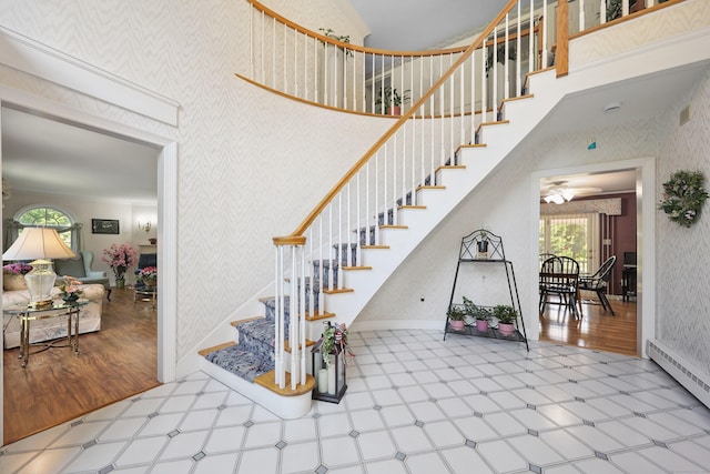 21 Hidden Pond Dr, Watertown, CT 06795 - stairway featuring wallpapered walls, tile patterned floors, a towering ceiling, a baseboard radiator, and ceiling fan