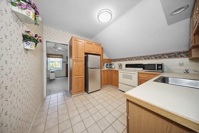 21 Hidden Pond Dr, Watertown, CT 06795 - kitchen with stainless steel appliances, lofted ceiling, light countertops, wallpapered walls, and light tile patterned floors