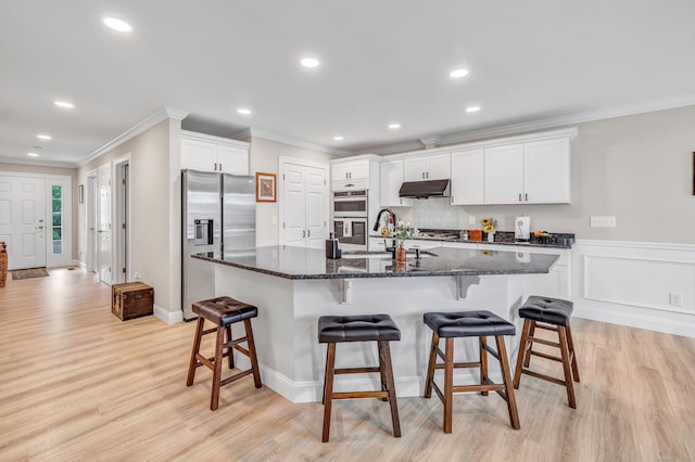 54 Pondview Cir Unit 54, Beacon Falls, CT 06403 - kitchen with stainless steel appliances, under cabinet range hood, crown molding, light wood-type flooring, and white cabinetry