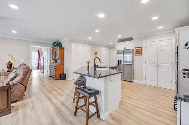 54 Pondview Cir Unit 54, Beacon Falls, CT 06403 - kitchen featuring stainless steel refrigerator with ice dispenser, ornamental molding, a breakfast bar, recessed lighting, and white cabinetry