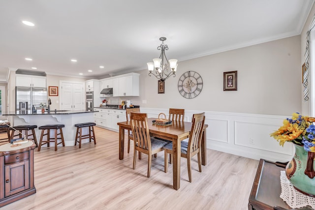 54 Pondview Cir Unit 54, Beacon Falls, CT 06403 - dining room with a chandelier, ornamental molding, recessed lighting, light wood finished floors, and a wainscoted wall
