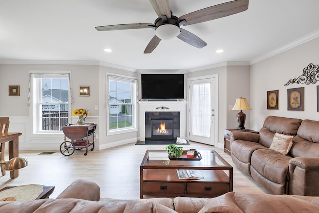 54 Pondview Cir Unit 54, Beacon Falls, CT 06403 - living area featuring light wood-style flooring, ornamental molding, a ceiling fan, a glass covered fireplace, and recessed lighting
