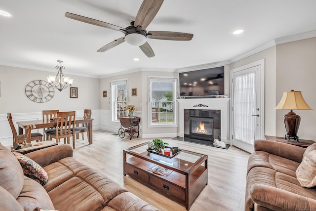 54 Pondview Cir Unit 54, Beacon Falls, CT 06403 - living room featuring ornamental molding, light wood-type flooring, a chandelier, a ceiling fan, and a glass covered fireplace