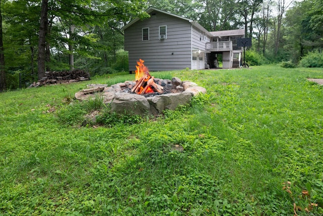 16 Skidmore Ln, Newtown, CT 06482 - view of green lawn featuring a fire pit, a wooden deck, and stairway