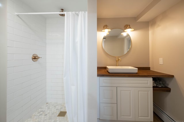 16 Skidmore Ln, Newtown, CT 06482 - bathroom featuring a baseboard heating unit, a tile shower, and vanity