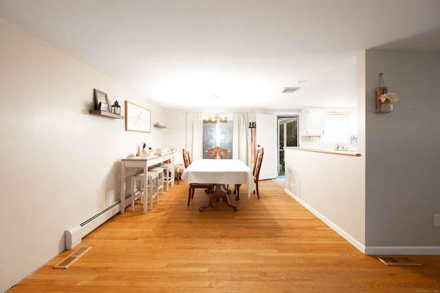 16 Skidmore Ln, Newtown, CT 06482 - dining space with a chandelier, light wood-type flooring, and a baseboard radiator
