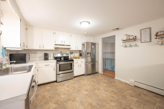 16 Skidmore Ln, Newtown, CT 06482 - kitchen featuring stainless steel appliances, under cabinet range hood, light countertops, decorative backsplash, and white cabinets