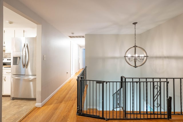 16 Skidmore Ln, Newtown, CT 06482 - corridor with a chandelier, an upstairs landing, and light wood-type flooring