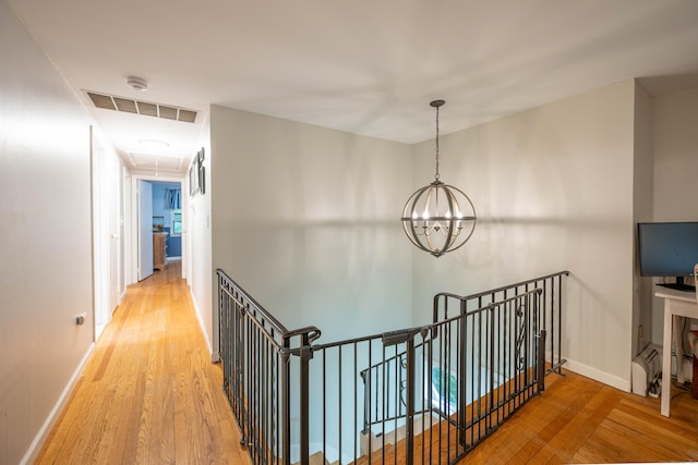 16 Skidmore Ln, Newtown, CT 06482 - corridor featuring attic access, an upstairs landing, light wood finished floors, and a chandelier