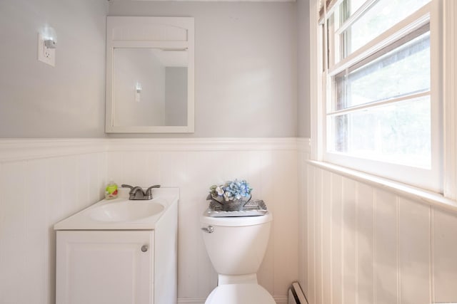 16 Skidmore Ln, Newtown, CT 06482 - half bath featuring a wainscoted wall, vanity, and healthy amount of natural light