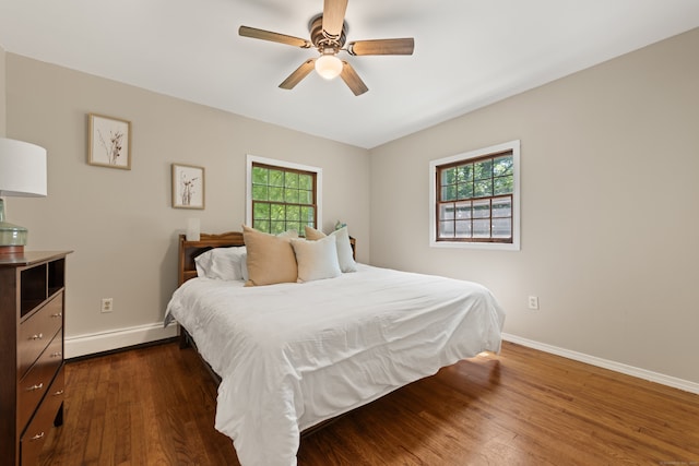 84 Kanungum Trl, Shelton, CT 06484 - bedroom with baseboard heating, multiple windows, dark wood-style flooring, and a ceiling fan