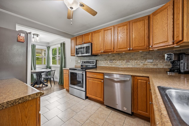 96 Douglas Dr, Meriden, CT 06451 - kitchen featuring stainless steel appliances, ornamental molding, backsplash, a ceiling fan, and light tile patterned floors