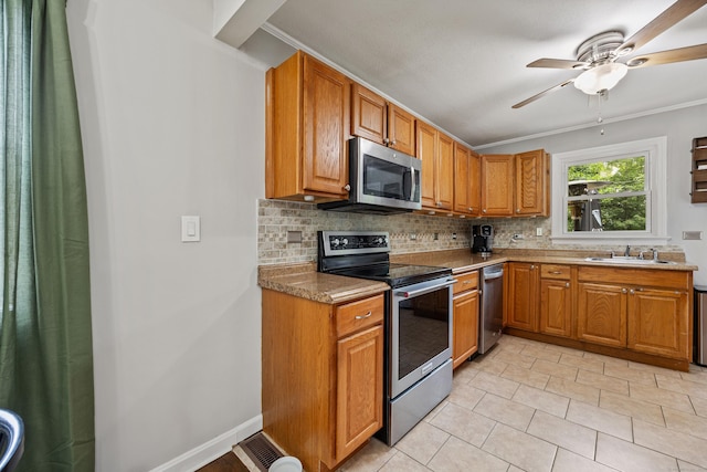 96 Douglas Dr, Meriden, CT 06451 - kitchen featuring stainless steel appliances, tasteful backsplash, a ceiling fan, brown cabinetry, and ornamental molding