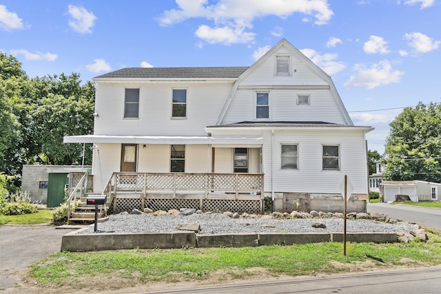 124 Geddes Ter, Waterbury, CT 06708 - view of front facade with covered porch, an outbuilding, and a gambrel roof