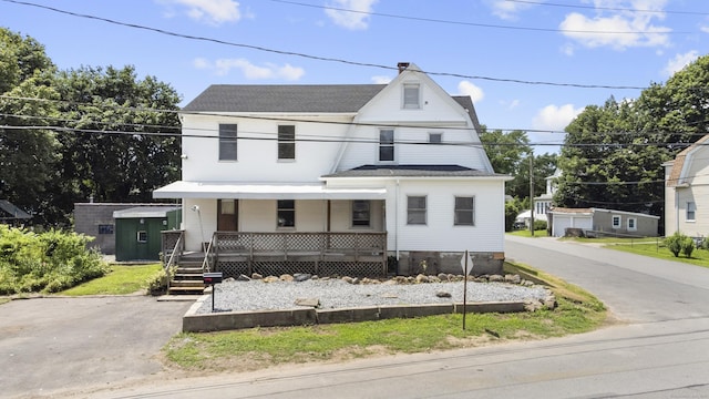 124 Geddes Ter, Waterbury, CT 06708 - view of front of property featuring covered porch, roof with shingles, and a shed