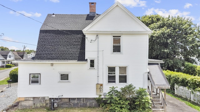 124 Geddes Ter, Waterbury, CT 06708 - rear view of property featuring a shingled roof and a chimney