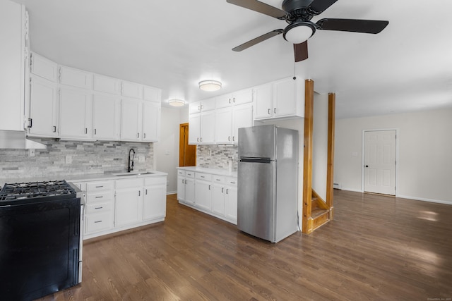 124 Geddes Ter, Waterbury, CT 06708 - kitchen featuring freestanding refrigerator, range with gas cooktop, ceiling fan, light countertops, and decorative backsplash