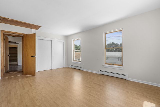 124 Geddes Ter, Waterbury, CT 06708 - unfurnished bedroom featuring a baseboard heating unit, light wood-style floors, and a closet