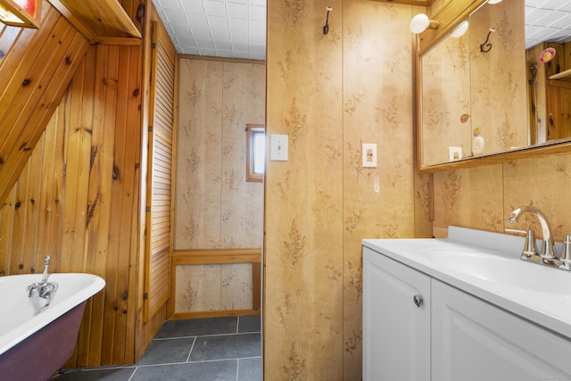 124 Geddes Ter, Waterbury, CT 06708 - full bathroom featuring a freestanding tub, vanity, wood walls, and tile patterned floors