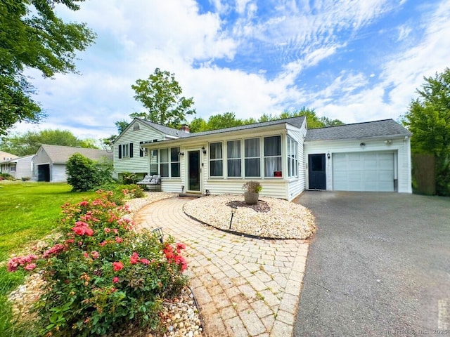 860 Suffield St, Suffield, CT 06078 - split level home with driveway, an attached garage, and a front lawn