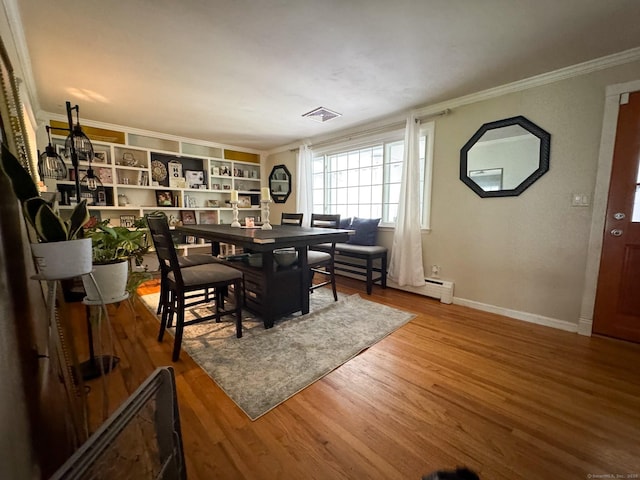 860 Suffield St, Suffield, CT 06078 - dining area featuring ornamental molding, baseboard heating, and wood finished floors