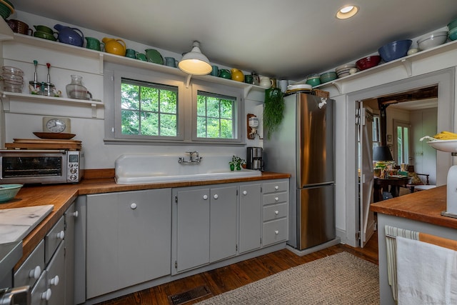 32 Cherniske Rd, New Milford, CT 06776 - kitchen with freestanding refrigerator, dark wood-type flooring, open shelves, butcher block counters, and gray cabinetry