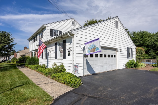 622 Wiese Rd, Cheshire, CT 06410 - view of side of home with asphalt driveway and an attached garage